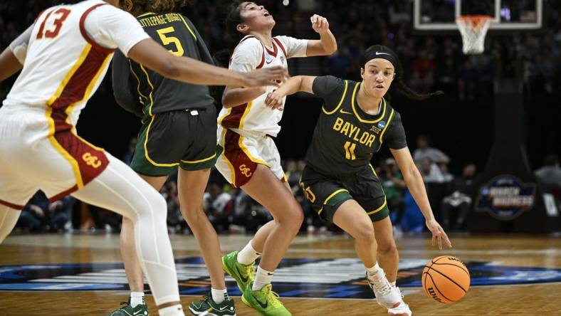 Mar 30, 2024; Portland, OR, USA; Baylor Lady Bears guard Jada Walker (11) drives to the basket during the first half against USC Trojans guard Kayla Padilla (45) in the semifinals of the Portland Regional of the 2024 NCAA Tournament at the Moda Center. Mandatory Credit: Troy Wayrynen-USA TODAY Sports