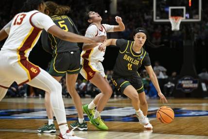 Mar 30, 2024; Portland, OR, USA; Baylor Lady Bears guard Jada Walker (11) drives to the basket during the first half against USC Trojans guard Kayla Padilla (45) in the semifinals of the Portland Regional of the 2024 NCAA Tournament at the Moda Center. Mandatory Credit: Troy Wayrynen-USA TODAY Sports