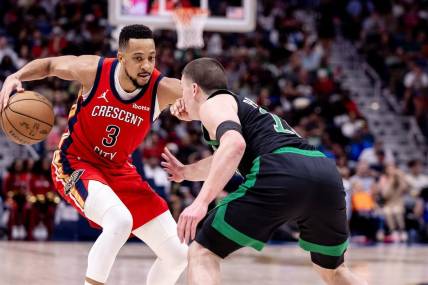 Mar 30, 2024; New Orleans, Louisiana, USA; New Orleans Pelicans guard CJ McCollum (3) dribbles against Boston Celtics guard Payton Pritchard (11) during the second half at Smoothie King Center. Mandatory Credit: Stephen Lew-USA TODAY Sports