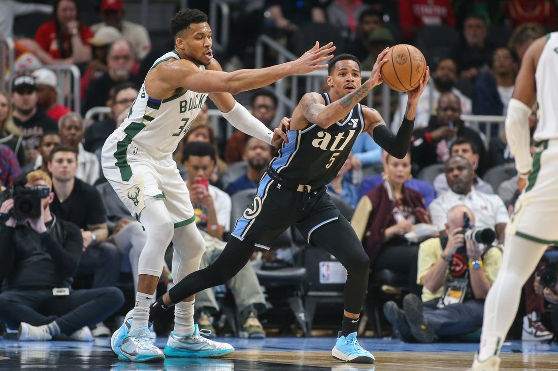 Mar 30, 2024; Atlanta, Georgia, USA; Milwaukee Bucks forward Giannis Antetokounmpo (34) defends Atlanta Hawks guard Dejounte Murray (5) in the first quarter at State Farm Arena. Mandatory Credit: Brett Davis-USA TODAY Sports