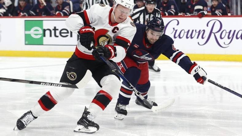 Mar 30, 2024; Winnipeg, Manitoba, CAN; Ottawa Senators left wing Brady Tkachuk (7) is chased down by Winnipeg Jets defenseman Neal Pionk (4) in the first period at Canada Life Centre. Mandatory Credit: James Carey Lauder-USA TODAY Sports