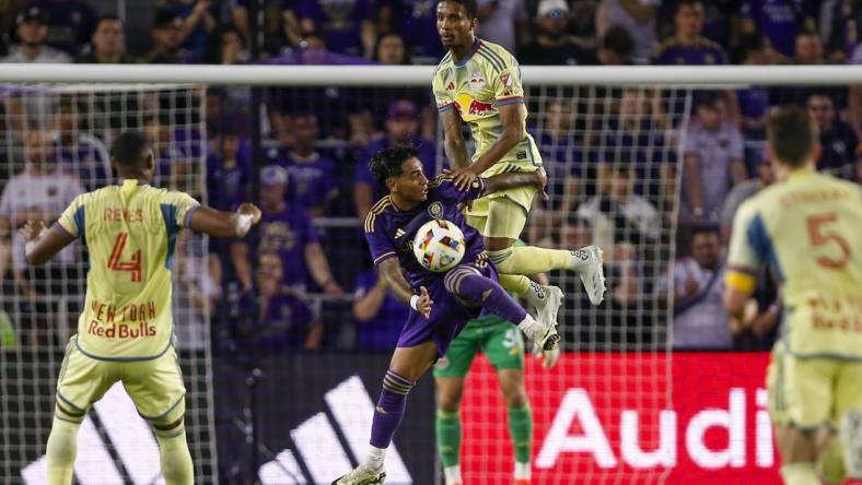 Mar 30, 2024; Orlando, Florida, USA; Orlando City midfielder Facundo Torres (10) and New York Red Bulls defender Kyle Duncan (6) battle for the ball during the first half at Inter&Co Stadium. Mandatory Credit: Russell Lansford-USA TODAY Sports