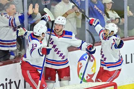 Mar 30, 2024; Tempe, Arizona, USA; New York Rangers defenseman Zac Jones (6) celebrates with left wing Alexis Lafreniere (13) and center Vincent Trocheck (16) after scoring a goal in the third period against the Arizona Coyotes at Mullett Arena. Mandatory Credit: Matt Kartozian-USA TODAY Sports