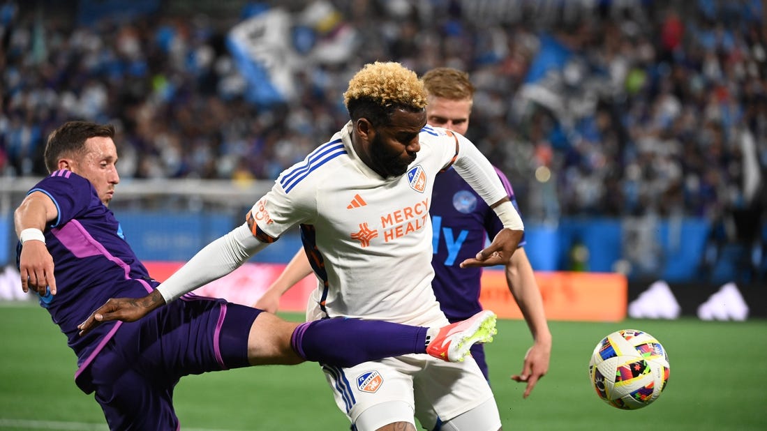 Mar 30, 2024; Charlotte, North Carolina, USA; Charlotte FC midfielder Brecht Dejaegere (10) and FC Cincinnati forward Aaron Boupendza (9) fight for the ball in the first half at Bank of America Stadium. Mandatory Credit: Bob Donnan-USA TODAY Sports