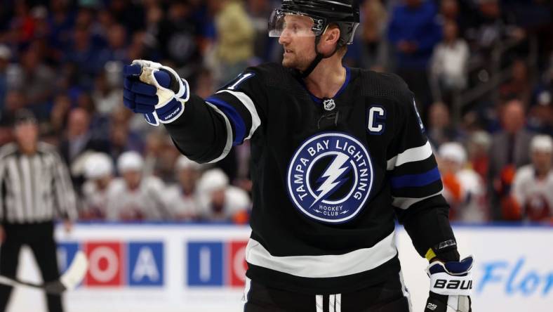 Mar 30, 2024; Tampa, Florida, USA; Tampa Bay Lightning center Steven Stamkos (91) points against the New York Islanders during the first period at Amalie Arena. Mandatory Credit: Kim Klement Neitzel-USA TODAY Sports