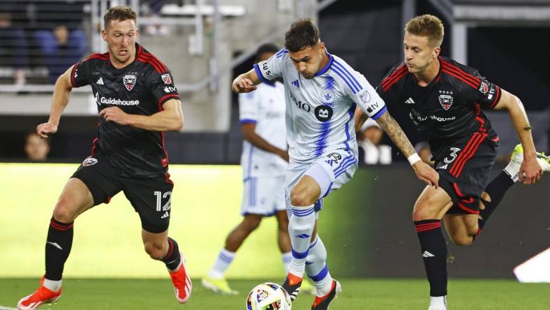 Mar 30, 2024; Washington, District of Columbia, USA; CF Montreal midfielder Dominic Iankov (8) runs with the ball as D.C. United defender Conner Antley (12) and D.C. United defender Lucas Bartlett (3) defend during the first half an at Audi Field. Mandatory Credit: Amber Searls-USA TODAY Sports