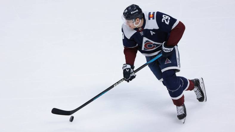 Mar 30, 2024; Denver, Colorado, USA; Colorado Avalanche center Nathan MacKinnon (29) skates with the puck during the third period against the Nashville Predators at Ball Arena. Mandatory Credit: Andrew Wevers-USA TODAY Sports