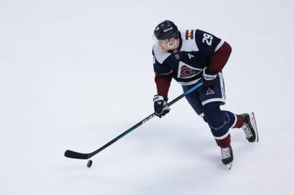 Mar 30, 2024; Denver, Colorado, USA; Colorado Avalanche center Nathan MacKinnon (29) skates with the puck during the third period against the Nashville Predators at Ball Arena. Mandatory Credit: Andrew Wevers-USA TODAY Sports