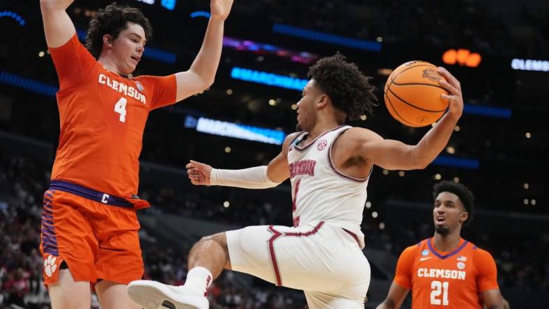 Mar 30, 2024; Los Angeles, CA, USA;  Alabama Crimson Tide guard Mark Sears (1) controls the ball against Clemson Tigers forward Ian Schieffelin (4) in the first half in the finals of the West Regional of the 2024 NCAA Tournament at Crypto.com Arena. Mandatory Credit: Kirby Lee-USA TODAY Sports