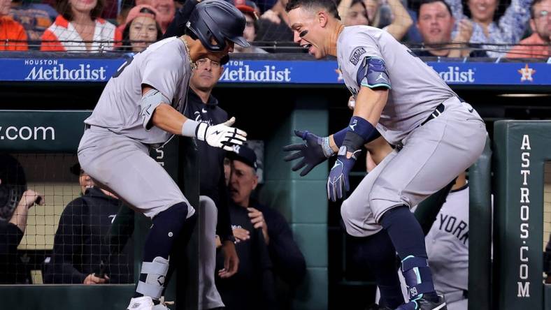 Mar 30, 2024; Houston, Texas, USA; New York Yankees third baseman Oswaldo Cabrera (95) celebrates with New York Yankees designated hitter Aaron Judge (99, right) after hitting a two-run home run to right field against the Houston Astros during the seventh inning at Minute Maid Park. Mandatory Credit: Erik Williams-USA TODAY Sports