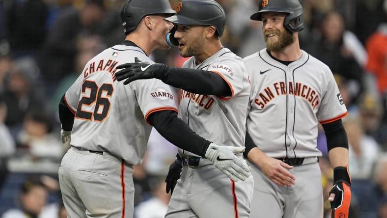 Mar 30, 2024; San Diego, California, USA; San Francisco Giants left fielder Michael Conforto (center) is congratulated by third baseman Matt Chapman (26) after hitting a grand slam home run against the San Diego Padres during the eighth inning at Petco Park. Mandatory Credit: Ray Acevedo-USA TODAY Sports