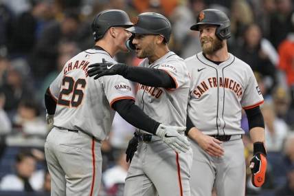 Mar 30, 2024; San Diego, California, USA; San Francisco Giants left fielder Michael Conforto (center) is congratulated by third baseman Matt Chapman (26) after hitting a grand slam home run against the San Diego Padres during the eighth inning at Petco Park. Mandatory Credit: Ray Acevedo-USA TODAY Sports