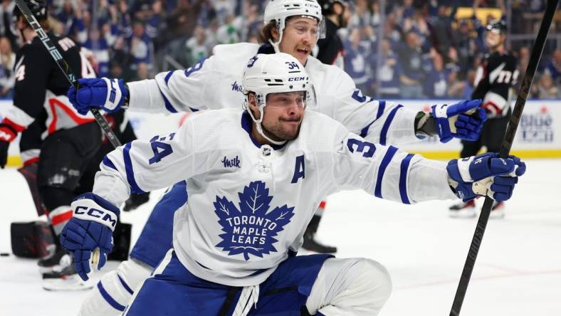 Mar 30, 2024; Buffalo, New York, USA;  Toronto Maple Leafs center Auston Matthews (34) reacts after scoring his 60th goal of the year during the third period against the Buffalo Sabres at KeyBank Center. Mandatory Credit: Timothy T. Ludwig-USA TODAY Sports