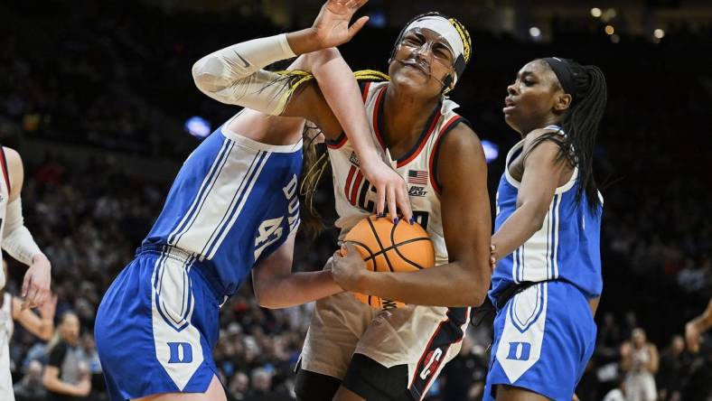 Mar 30, 2024; Portland, OR, USA; UConn Huskies forward Aaliyah Edwards (3) is fouled by Duke Blue Devils center Kennedy Brown (42) during the second half in the semifinals of the Portland Regional of the 2024 NCAA Tournament at the Moda Center. Mandatory Credit: Troy Wayrynen-USA TODAY Sports