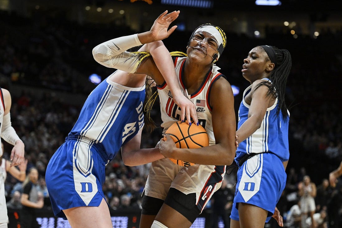 Mar 30, 2024; Portland, OR, USA; UConn Huskies forward Aaliyah Edwards (3) is fouled by Duke Blue Devils center Kennedy Brown (42) during the second half in the semifinals of the Portland Regional of the 2024 NCAA Tournament at the Moda Center. Mandatory Credit: Troy Wayrynen-USA TODAY Sports