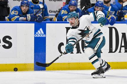 Mar 30, 2024; St. Louis, Missouri, USA;  San Jose Sharks defenseman Kyle Burroughs (4) shoots against the St. Louis Blues during the third period at Enterprise Center. Mandatory Credit: Jeff Curry-USA TODAY Sports