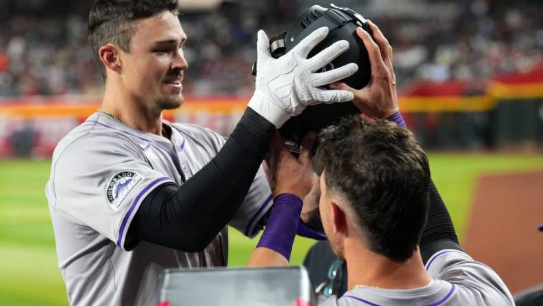 Mar 30, 2024; Phoenix, Arizona, USA; Colorado Rockies center fielder Brenton Doyle (9) celebrates with teammates in the dugout after hitting a two run home run against the Arizona Diamondbacks during the eighth inning at Chase Field. Mandatory Credit: Joe Camporeale-USA TODAY Sports