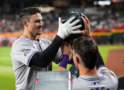 Mar 30, 2024; Phoenix, Arizona, USA; Colorado Rockies center fielder Brenton Doyle (9) celebrates with teammates in the dugout after hitting a two run home run against the Arizona Diamondbacks during the eighth inning at Chase Field. Mandatory Credit: Joe Camporeale-USA TODAY Sports