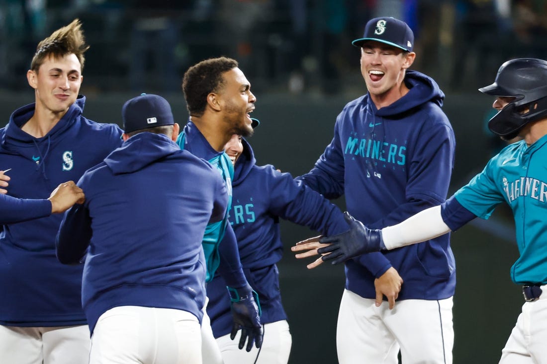 Mar 30, 2024; Seattle, Washington, USA; Seattle Mariners center fielder Julio Rodriguez (44, middle) celebrates after hitting a walk-off RBI-single against the Boston Red Sox during the tenth inning at T-Mobile Park. Mandatory Credit: Joe Nicholson-USA TODAY Sports