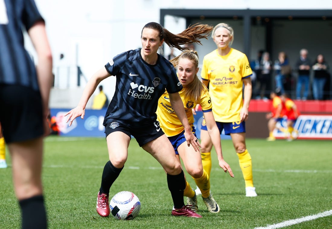 Mar 31, 2024; Washington, District of Columbia, USA; Washington Spirit midfielder Andi Sullivan (12) dribbles the ball against Utah Royals FC midfielder Dana Foederer (22) during the first half of the match at Audi Field. Mandatory Credit: Amber Searls-USA TODAY Sports