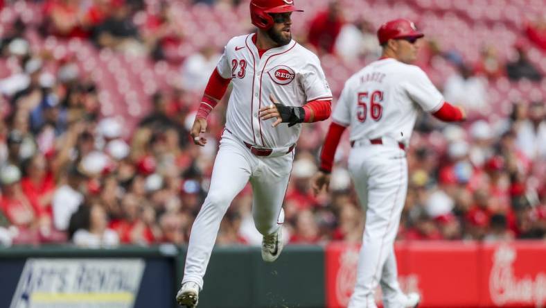 Mar 31, 2024; Cincinnati, Ohio, USA; Cincinnati Reds designated hitter Nick Martini (23) scores on a double hit by center fielder Will Benson (30) in the third inning against the Washington Nationals at Great American Ball Park. Mandatory Credit: Katie Stratman-USA TODAY Sports