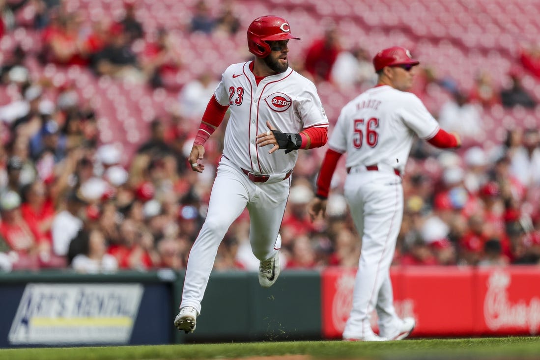 Mar 31, 2024; Cincinnati, Ohio, USA; Cincinnati Reds designated hitter Nick Martini (23) scores on a double hit by center fielder Will Benson (30) in the third inning against the Washington Nationals at Great American Ball Park. Mandatory Credit: Katie Stratman-USA TODAY Sports