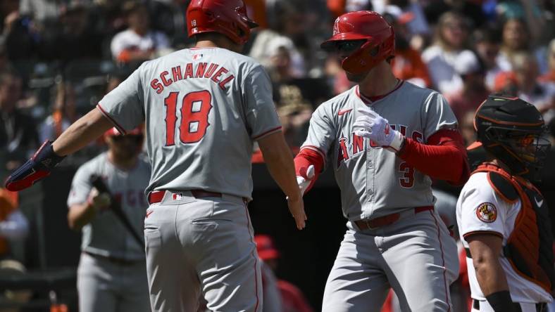 Mar 31, 2024; Baltimore, Maryland, USA;  Los Angeles Angels left fielder Taylor Ward (3) celebrates with  first baseman Nolan Schanuel (18) at home plate after hitting a first inning home run H| at Oriole Park at Camden Yards. Mandatory Credit: Tommy Gilligan-USA TODAY Sports