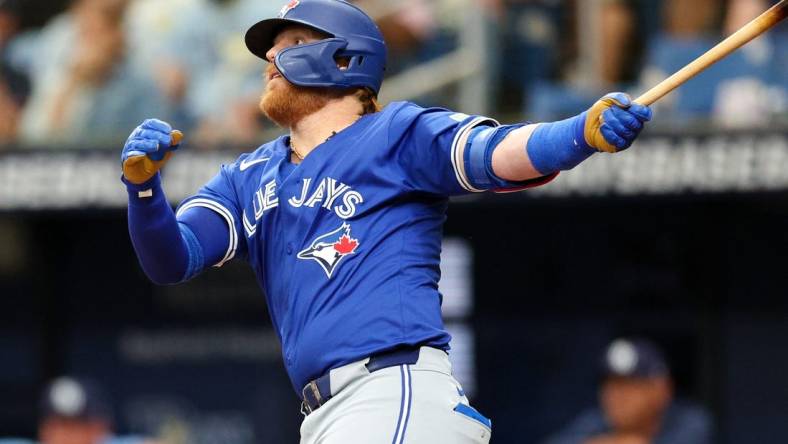 Mar 31, 2024; St. Petersburg, Florida, USA;  Toronto Blue Jays third baseman Justin Turner (2) hits a solo home run against the Tampa Bay Rays in the fifth inning at Tropicana Field. Mandatory Credit: Nathan Ray Seebeck-USA TODAY Sports