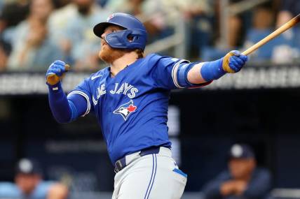 Mar 31, 2024; St. Petersburg, Florida, USA;  Toronto Blue Jays third baseman Justin Turner (2) hits a solo home run against the Tampa Bay Rays in the fifth inning at Tropicana Field. Mandatory Credit: Nathan Ray Seebeck-USA TODAY Sports