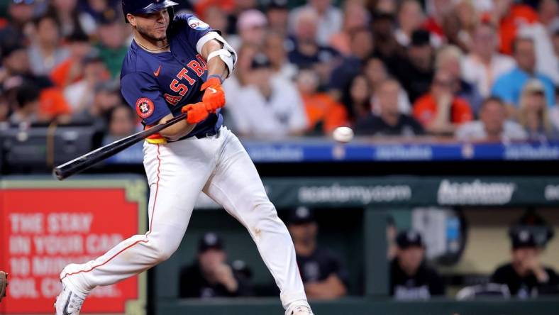 Mar 31, 2024; Houston, Texas, USA; Houston Astros designated hitter Yainer Diaz (21) hits an RBI single against the New York Yankees during the sixth inning at Minute Maid Park. Mandatory Credit: Erik Williams-USA TODAY Sports