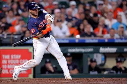 Mar 31, 2024; Houston, Texas, USA; Houston Astros designated hitter Yainer Diaz (21) hits an RBI single against the New York Yankees during the sixth inning at Minute Maid Park. Mandatory Credit: Erik Williams-USA TODAY Sports