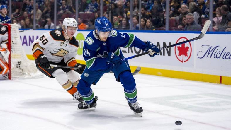 Mar 31, 2024; Vancouver, British Columbia, CAN; Anaheim Ducks defenseman Jackson LaCombe (60) defends against Vancouver Canucks forward Pius Suter (24) in the first period at Rogers Arena. Mandatory Credit: Bob Frid-USA TODAY Sports