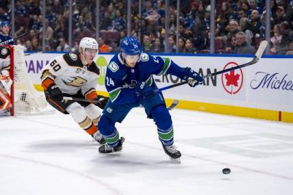 Mar 31, 2024; Vancouver, British Columbia, CAN; Anaheim Ducks defenseman Jackson LaCombe (60) defends against Vancouver Canucks forward Pius Suter (24) in the first period at Rogers Arena. Mandatory Credit: Bob Frid-USA TODAY Sports