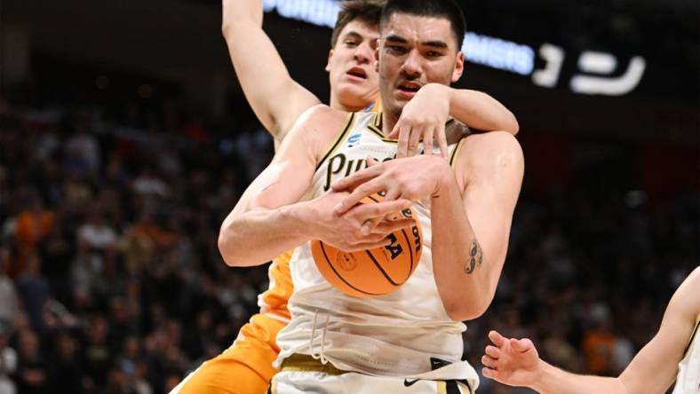 Mar 31, 2024; Detroit, MI, USA; Purdue Boilermakers center Zach Edey (15) controls the ball defended by Tennessee Volunteers forward J.P. Estrella (13) in the second half during the NCAA Tournament Midwest Regional Championship- at Little Caesars Arena. Mandatory Credit: Lon Horwedel-USA TODAY Sports