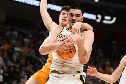 Mar 31, 2024; Detroit, MI, USA; Purdue Boilermakers center Zach Edey (15) controls the ball defended by Tennessee Volunteers forward J.P. Estrella (13) in the second half during the NCAA Tournament Midwest Regional Championship- at Little Caesars Arena. Mandatory Credit: Lon Horwedel-USA TODAY Sports