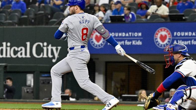 Mar 31, 2024; Arlington, Texas, USA; Chicago Cubs designated hitter Ian Happ (8) hits a double and drives in two runs during the fourth inning against the Texas Rangers at Globe Life Field. Mandatory Credit: Jerome Miron-USA TODAY Sports