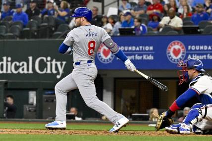 Mar 31, 2024; Arlington, Texas, USA; Chicago Cubs designated hitter Ian Happ (8) hits a double and drives in two runs during the fourth inning against the Texas Rangers at Globe Life Field. Mandatory Credit: Jerome Miron-USA TODAY Sports