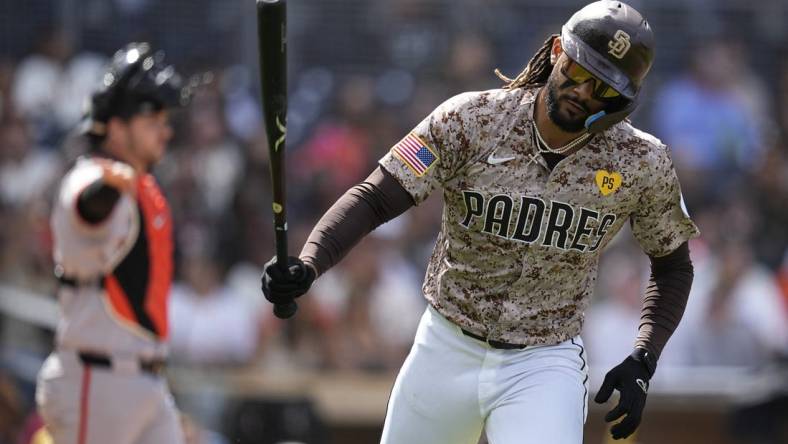 Mar 31, 2024; San Diego, California, USA; San Diego Padres right fielder Fernando Tatis Jr. (23) tosses his bat after hitting a ground ball during the fourth inning against the San Francisco Giants at Petco Park. Mandatory Credit: Ray Acevedo-USA TODAY Sports