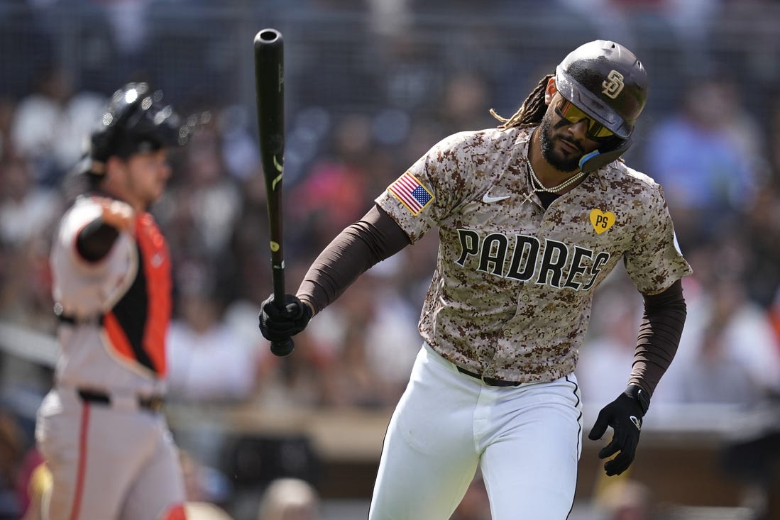 Mar 31, 2024; San Diego, California, USA; San Diego Padres right fielder Fernando Tatis Jr. (23) tosses his bat after hitting a ground ball during the fourth inning against the San Francisco Giants at Petco Park. Mandatory Credit: Ray Acevedo-USA TODAY Sports