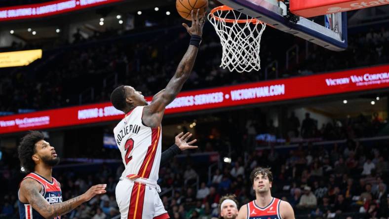 Mar 31, 2024; Washington, District of Columbia, USA; Miami Heat guard Terry Rozier (2) shoots a layup over Washington Wizards forward Marvin Bagley III (35) during the first quarter at Capital One Arena. Mandatory Credit: Reggie Hildred-USA TODAY Sports