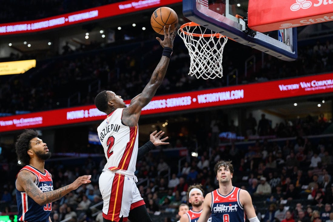 Mar 31, 2024; Washington, District of Columbia, USA; Miami Heat guard Terry Rozier (2) shoots a layup over Washington Wizards forward Marvin Bagley III (35) during the first quarter at Capital One Arena. Mandatory Credit: Reggie Hildred-USA TODAY Sports