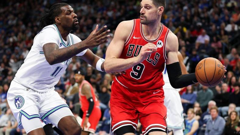 Mar 31, 2024; Minneapolis, Minnesota, USA; Chicago Bulls center Nikola Vucevic (9) passes as Minnesota Timberwolves center Naz Reid (11) defends during the first half at Target Center. Mandatory Credit: Matt Krohn-USA TODAY Sports