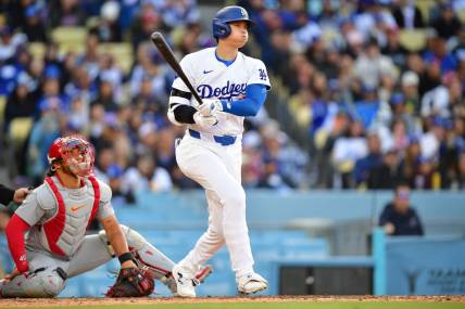 Mar 31, 2024; Los Angeles, California, USA; Los Angeles Dodgers designated hitter Shohei Ohtani (17) hits a double against the St. Louis Cardinals during the sixth inning at Dodger Stadium. Mandatory Credit: Gary A. Vasquez-USA TODAY Sports