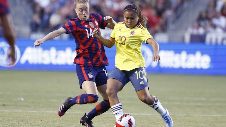 Jun 28, 2022; Sandy, Utah, USA; USA defender Emily Sonett (14) and Columbia midfielder Leicy Santos (10) battle in the first half during an international friendly soccer match at Rio Tinto Stadium. Mandatory Credit: Jeffrey Swinger-USA TODAY Sports