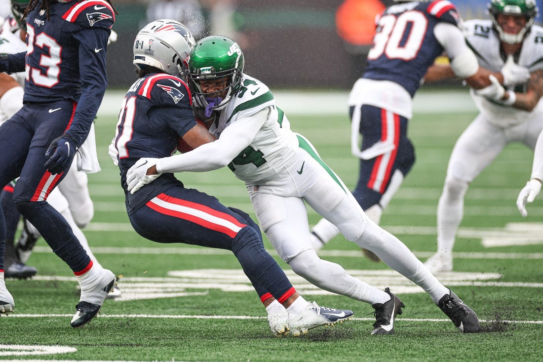 Sep 24, 2023; East Rutherford, New Jersey, USA; New England Patriots wide receiver Demario Douglas (81) is tackled by New York Jets cornerback Justin Hardee (34) during the first half at MetLife Stadium. Mandatory Credit: Vincent Carchietta-USA TODAY Sports