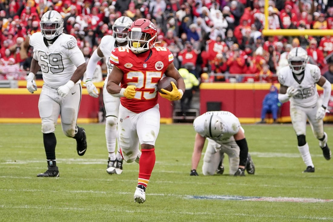 Dec 25, 2023; Kansas City, Missouri, USA; Kansas City Chiefs running back Clyde Edwards-Helaire (25) runs the ball against the Las Vegas Raiders during the game at GEHA Field at Arrowhead Stadium. Mandatory Credit: Denny Medley-USA TODAY Sports