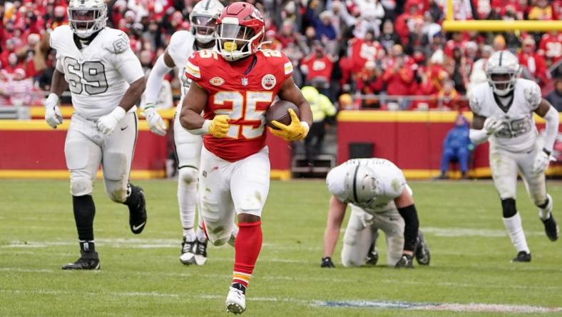 Dec 25, 2023; Kansas City, Missouri, USA; Kansas City Chiefs running back Clyde Edwards-Helaire (25) runs the ball against the Las Vegas Raiders during the game at GEHA Field at Arrowhead Stadium. Mandatory Credit: Denny Medley-USA TODAY Sports