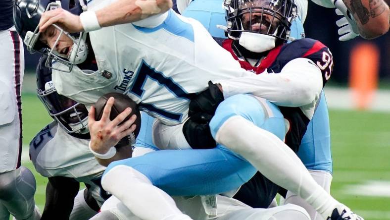 Tennessee Titans quarterback Ryan Tannehill (17) is sacked by Houston Texans defensive end Derek Barnett (95) on a fourth down during the fourth quarter at NRG Stadium in Houston, Texas., Sunday, Dec. 31, 2023.