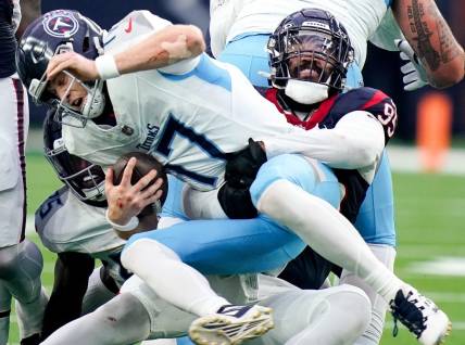 Tennessee Titans quarterback Ryan Tannehill (17) is sacked by Houston Texans defensive end Derek Barnett (95) on a fourth down during the fourth quarter at NRG Stadium in Houston, Texas., Sunday, Dec. 31, 2023.