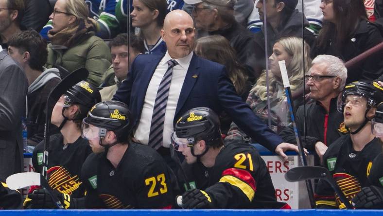 Feb 15, 2024; Vancouver, British Columbia, CAN; Vancouver Canucks head coach Rick Tocchet on the bench against the Detroit Red Wings in the first period at Rogers Arena. Mandatory Credit: Bob Frid-USA TODAY Sports